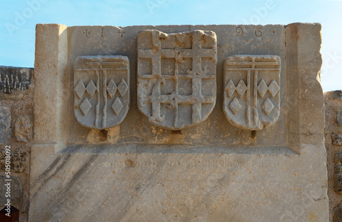 Coat of arms of the Order of Knights of the Hospital or Hospitallers on the wall of Bodrum Castle or Bodrum fortress or Castle of St. Peter or Petronium, Turkey photo