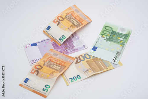 fifty euro banknotes  on five hundred and two hundred euro banknotes  and on the latter a one hundred euro banknote  forming a beautiful harmony of colors which can be used for any financial  economic