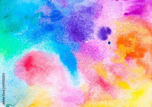 Hand drawn watercolor stains making up rainbow on paper. Aquarelle paint for a colorful background.