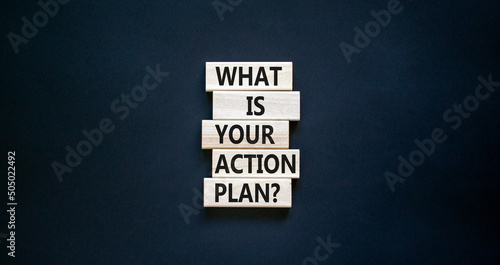 Action plan symbol. Concept words What is your action plan on wooden blocks. Beautiful black table black background. Business What is your action plan concept. Copy space. photo