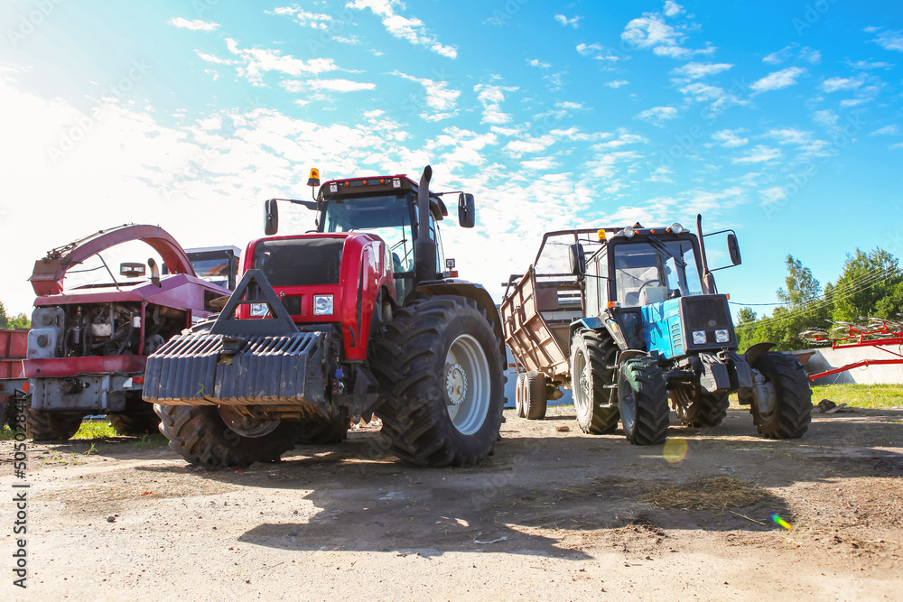 Agricultural machinery, tractors and equipment outdoors, near the garage, ready to work in the field. Agricultural machinery, tractors and equipment outdoors, near the garage, ready to work in the field.