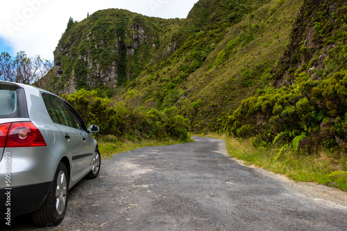 Obraz na plátně Landscape view over an old secondary traditional road with a car parked on the side, in Lombadas Springs on the island of Sao Miguel, Azores, Portugal