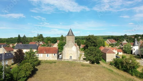 The church in the middle of the French village of Beuvron in Europe, France, Burgundy, Nievre, in summer, on a stormy day. photo