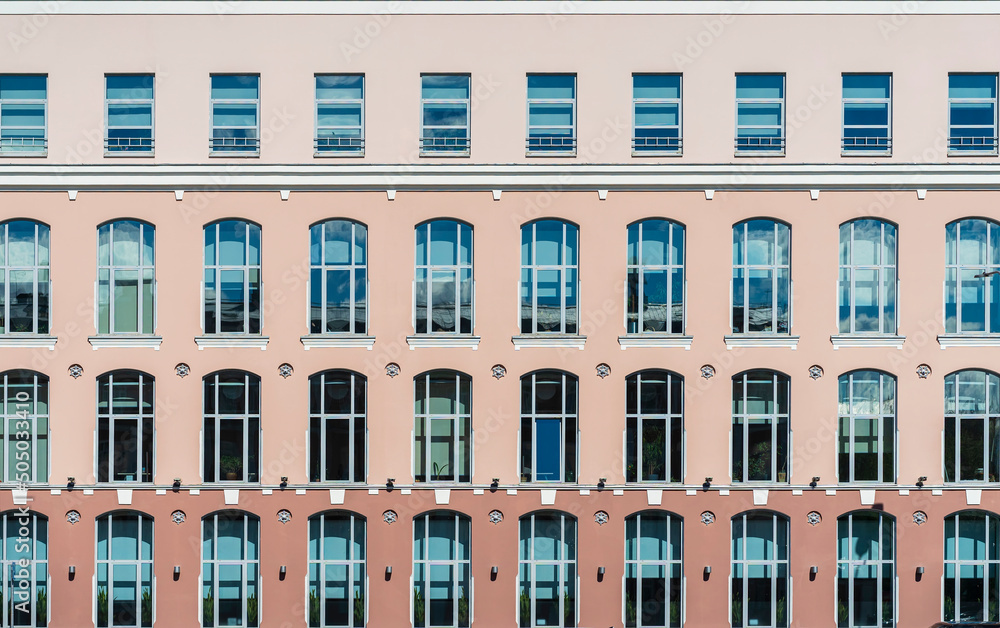 Building background. Front view of windows on colorful wall, modern architecture