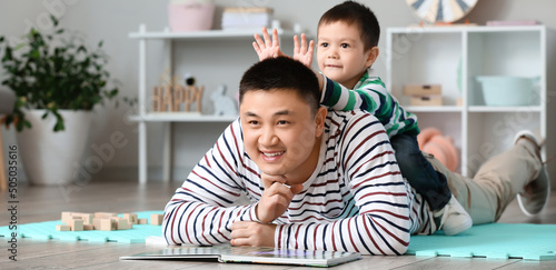 Happy Asian father and his ...