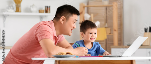 Asian father and his little...