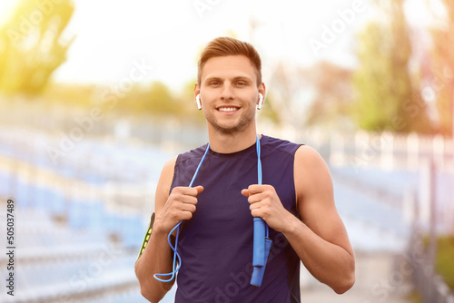 Sporty young man with skipp...