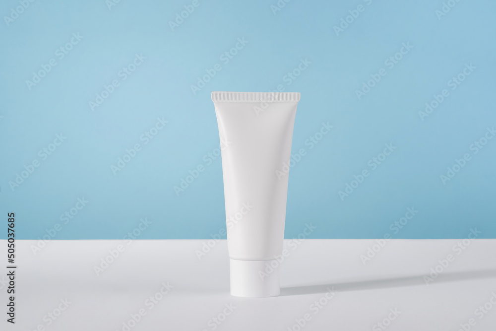 Moisturiser hand cosmetic cream white plastic tube mockup on blue ...
