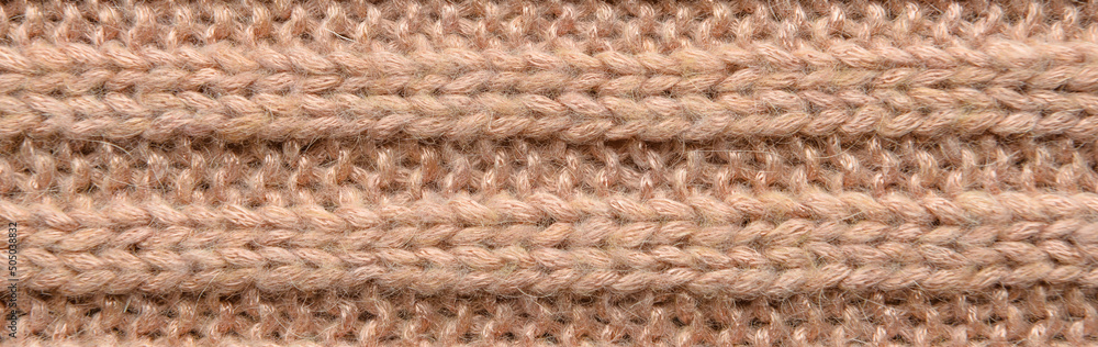 Texture of brown knitted fabric as background. Banner for design Texture of brown knitted fabric as background. Banner for design