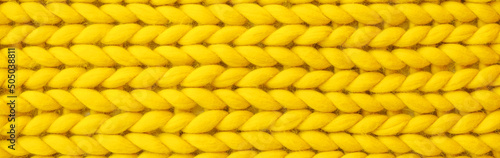 Texture of yellow knitted fabric as background, top view. Banner for design