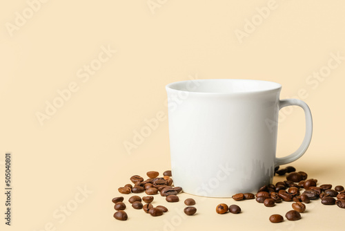 Ceramic cup and coffee beans on color background