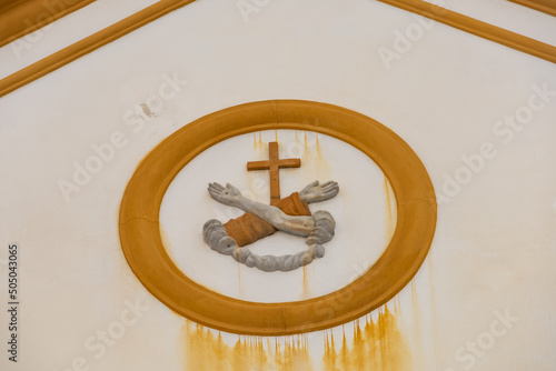 Christian symbol crossed arms and a cross on the facade of the Catholic church of St. Francis in the center of Florianopolis Brazil photo