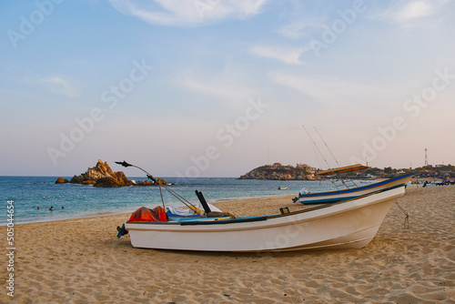 Landscape of the bay of San Agustin in Oaxaca Mexico. Huatulco beaches  paradisiacal beach. Fisherman s boats on the sand. Trunk of San Agust  n Huatulco. Sunset on Mexican beaches.