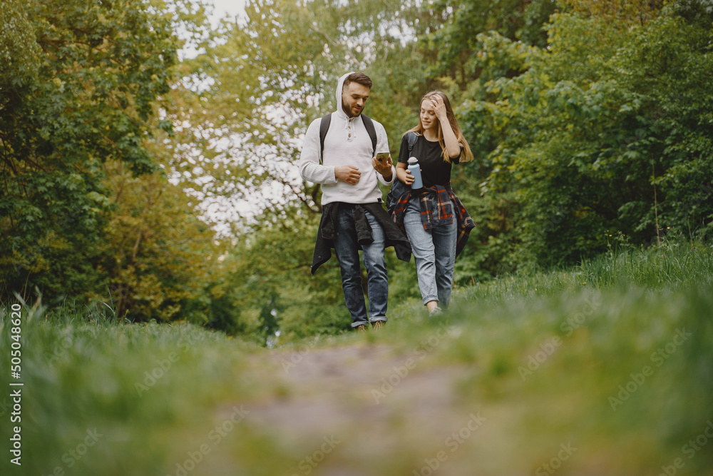 Cute couple have a rest in a summer forest Cute couple have a rest in a summer forest