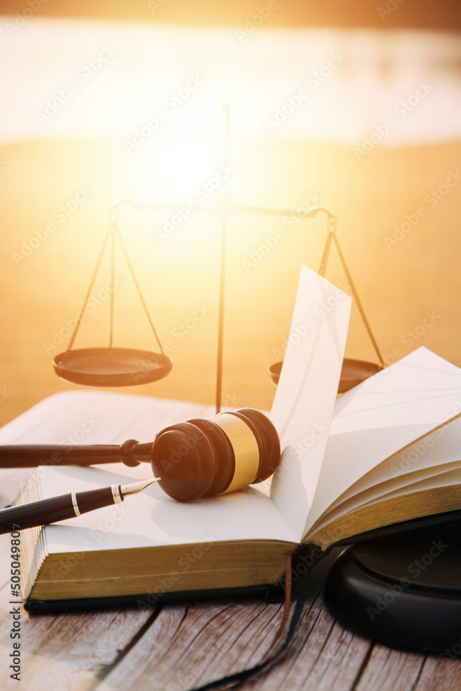 Business and lawyers discussing contract papers with brass scale on desk in office. Law, legal services, advice, justice and law concept picture with film grain effect Business and lawyers discussing contract papers with brass scale on desk in office. Law, legal services, advice, justice and law concept picture with film grain effect