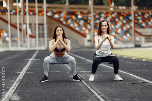 Two sports girls in a uniform training at the stadium