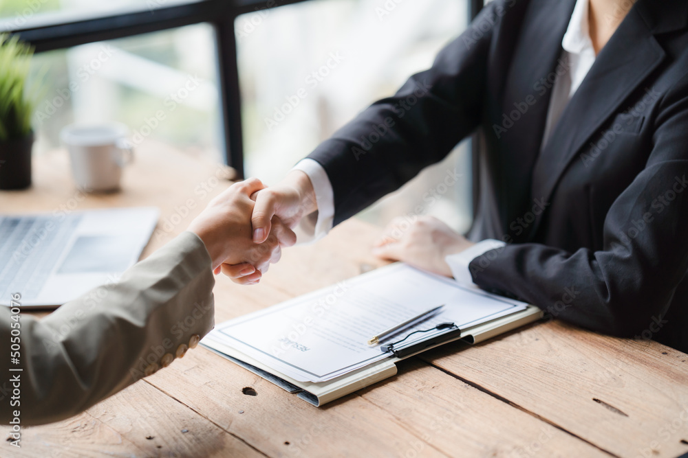Handshake of businesspeople. Female and male hand makes a handshake in the office, Business people shaking hands, finishing up a meeting. Handshake of businesspeople. Female and male hand makes a handshake in the office, Business people shaking hands, finishing up a meeting.