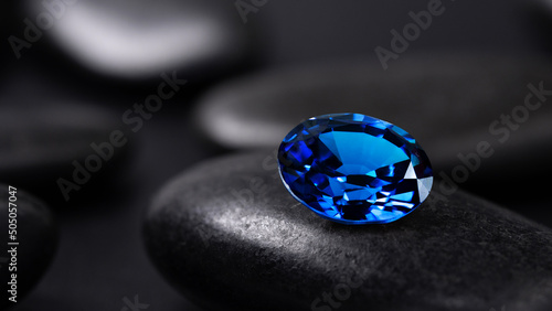 blue sapphire on black stone background photo
