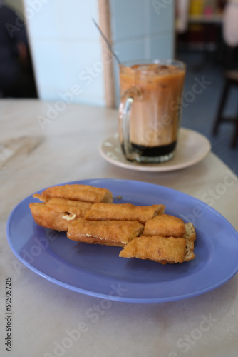 Local tea time snack, you tiao with kaya and butter with Three layers milk tea photo