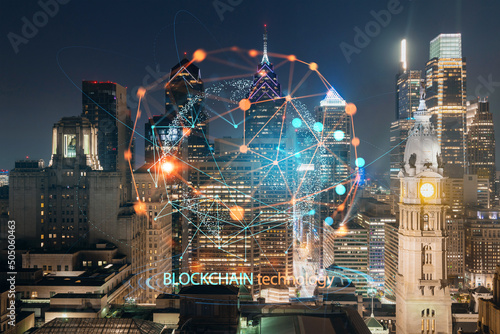 Aerial panoramic cityscape of Philadelphia financial downtown at summer night time, Pennsylvania, USA. Decentralized economy. Blockchain, cryptocurrency and cryptography concept, hologram