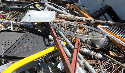 scrap metal and rusty ferrous waste in a landfill for recyclable materials photo