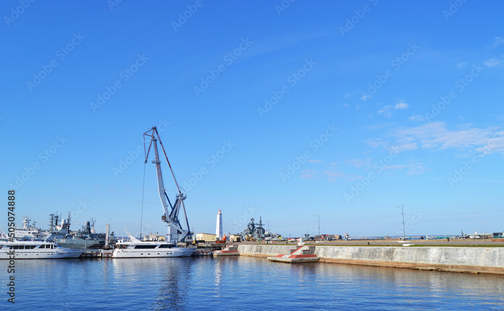 Crane and ships near the pier of the Gulf of Finland in Kronstadt