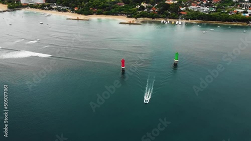 Beautiful cinematic Sanur beach, Bali drone footage with interesting landscape, fishing boats, hotel, resorts and calm weather. This footage was shot during Sunrise time in 1080p. photo