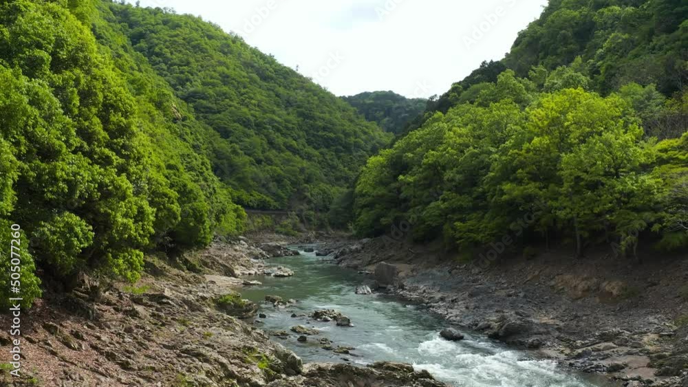 Hozukyo Bridge and Katsura River, Aerial Pullback in Arashiyama, Kyoto Japan Hozukyo Bridge and Katsura River, Aerial Pullback in Arashiyama, Kyoto Japan