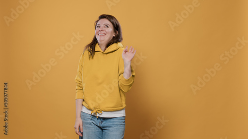 Φωτογραφία Young woman posing shy feeling embarrassed and awkward asking please stop with timid gesturing in studio