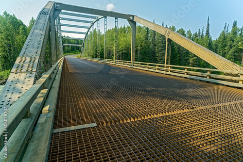 The metal grate surface of the Bell River Bridge #1 in British Columbia, Canada photo
