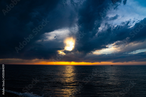 Black clouds over the sea at sunset time