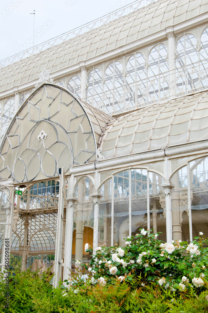 Greenhouse structure with flowering plants in Florence, Italy