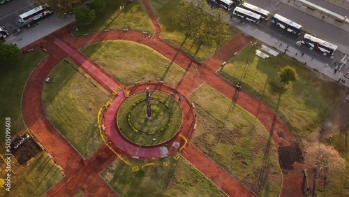 Aerial top down shot of park in front of Retiro Train Station with parking buses
