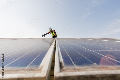 worker installing the solar panels.Solar power energy. renewable energy, Solar power plant. worker maintenance of solar power plants who perform inspections and maintenance of solar power plants.