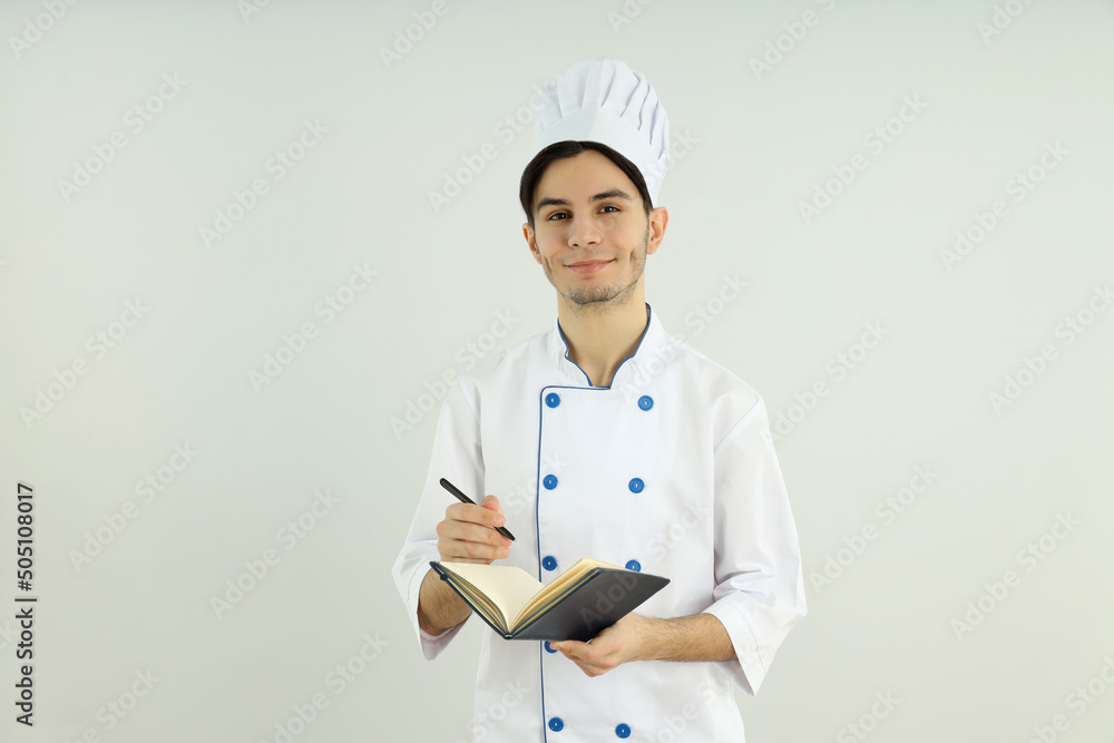 Concept of cooking, young man chef on light background Concept of cooking, young man chef on light background