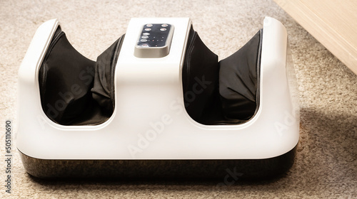 Foot massager. Close-up of an electric massager device. photo