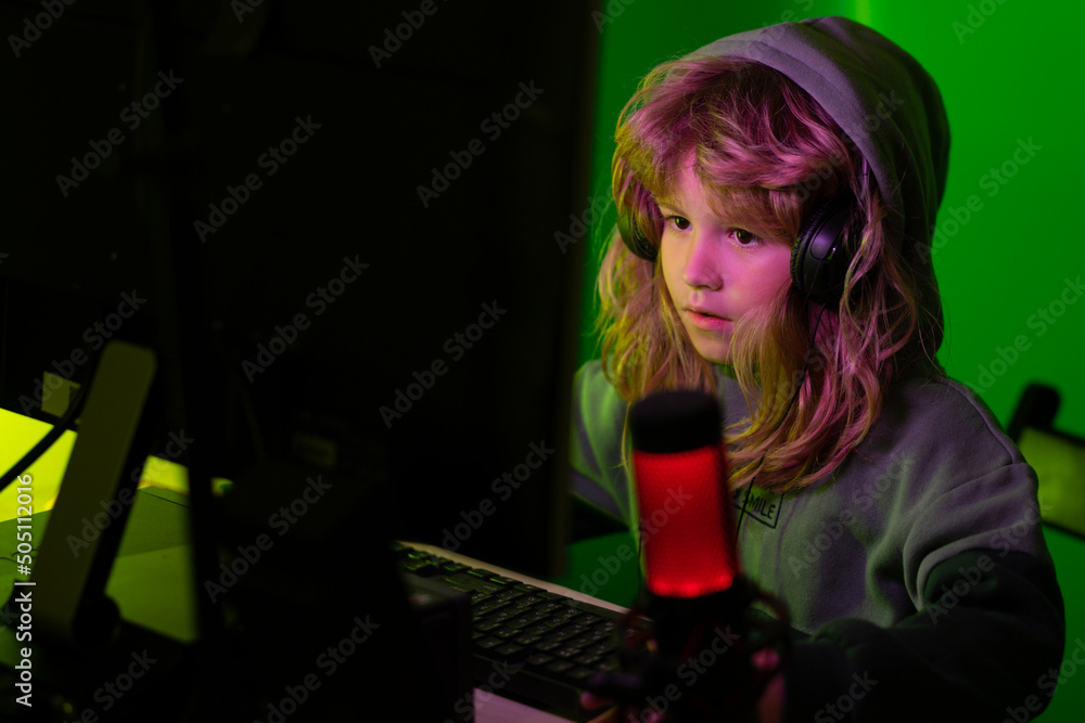 Little hacker, young programmer. Blogging and gaming concept. Kid or blogger with pc computer recording video at home. Night surf in the Internet. Little hacker, young programmer. Blogging and gaming concept. Kid or blogger with pc computer recording video at home. Night surf in the Internet.