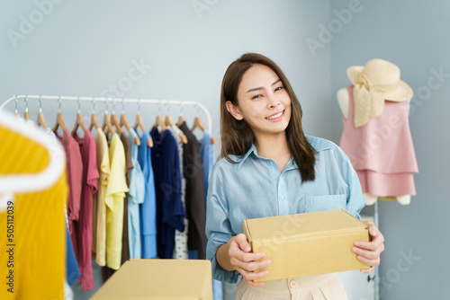 Female online seller sells a clothes via online marketplace platform.