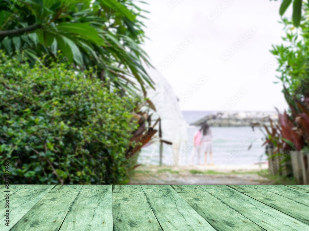 Wooden table (Perspective). and walkway down to beach, trees, palms, sea, daytime, blur, copy space