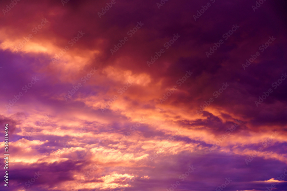 Colorful sunset in the evening sky. Clouds illuminated by the setting sun. Amazing sky panorama. Meditative calmness and greatness. Mystical lighting. Great dramatic view