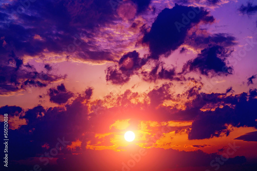 Great dramatic view. Amazing sky panorama. Clouds illuminated by the setting sun. Meditative calmness and greatness. Colorful sunset in the evening sky. Red sun in the clouds