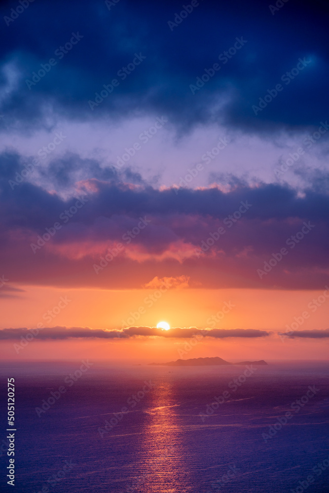 Colorful sunset in the evening sky. Great dramatic view. Amazing sky panorama. Meditative calmness and greatness. Red sun in the clouds. Clouds illuminated by the setting sun