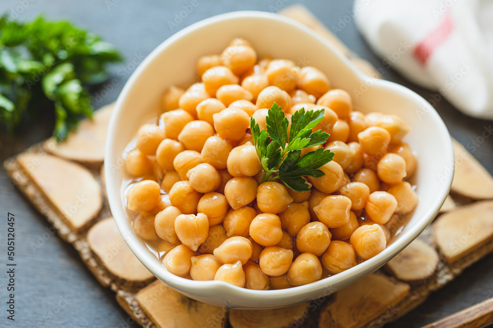 Cooked chickpeas in white bowl. Ingredient for Tasty vegetarian food. Boiled chickpeas, selective focus Cooked chickpeas in white bowl. Ingredient for Tasty vegetarian food. Boiled chickpeas, selective focus