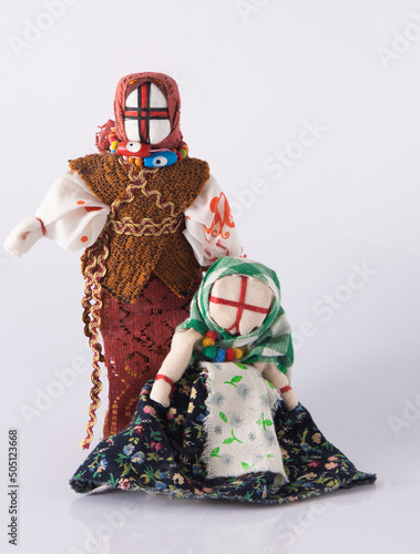 Lyalka motanka handmade. Ukrainian national doll amulet, silt patches and threads are made without a needle. Symbol of Ukraine. Motanka dolls on a white background. Old toy. photo