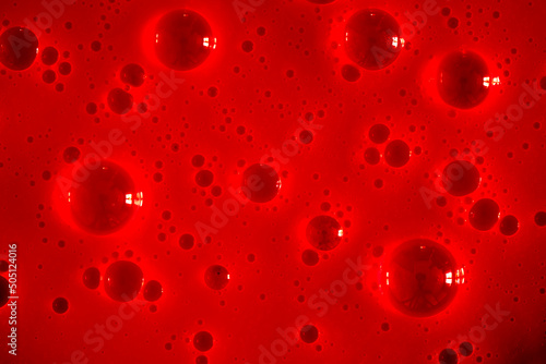 Bubble red background texture. Berry gel to cleanse the skin of the face and body. Spa treatments, skin care. Bath foam, detergent. Slime pink.