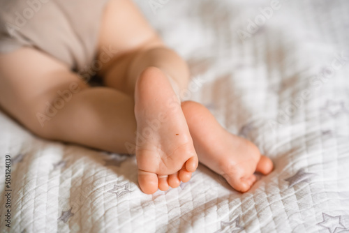 Baby heels on the blanket, little baby feet, selective focus, copy space