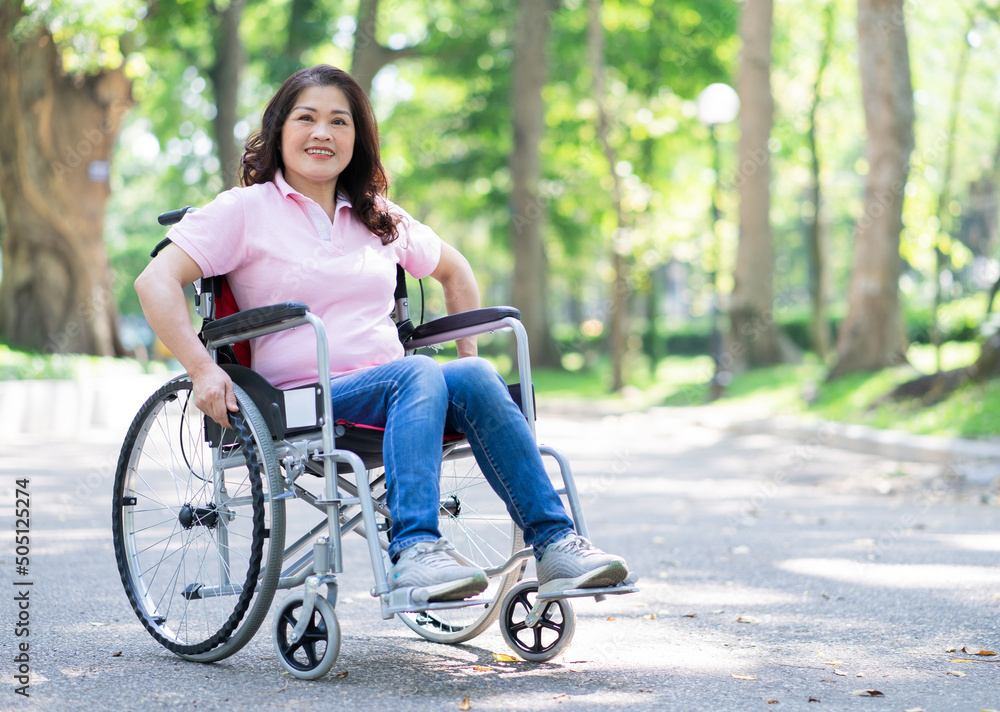 Image of middle-age Asian woman sitting on wheelchair Image of middle-age Asian woman sitting on wheelchair