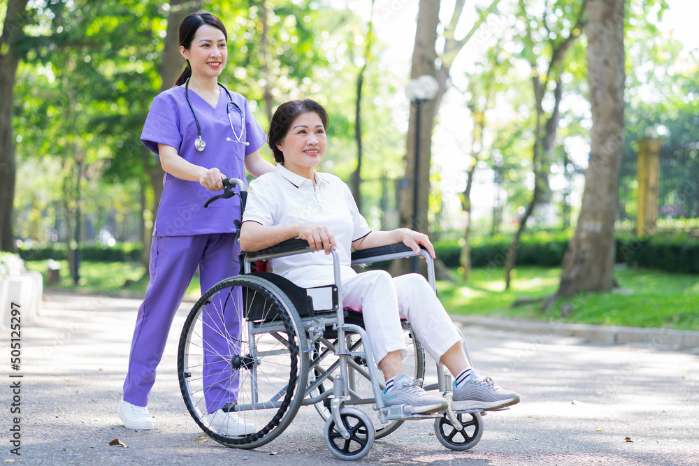 Asian female nurse taking care of a middle-aged female patient in the park Asian female nurse taking care of a middle-aged female patient in the park