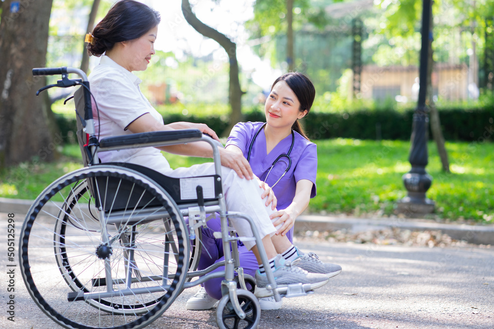 Asian female nurse taking care of a middle-aged female patient in the park Asian female nurse taking care of a middle-aged female patient in the park