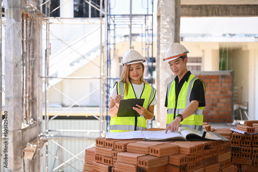Female inspectors discussing with engineer about construction project Female inspectors discussing with engineer about construction project